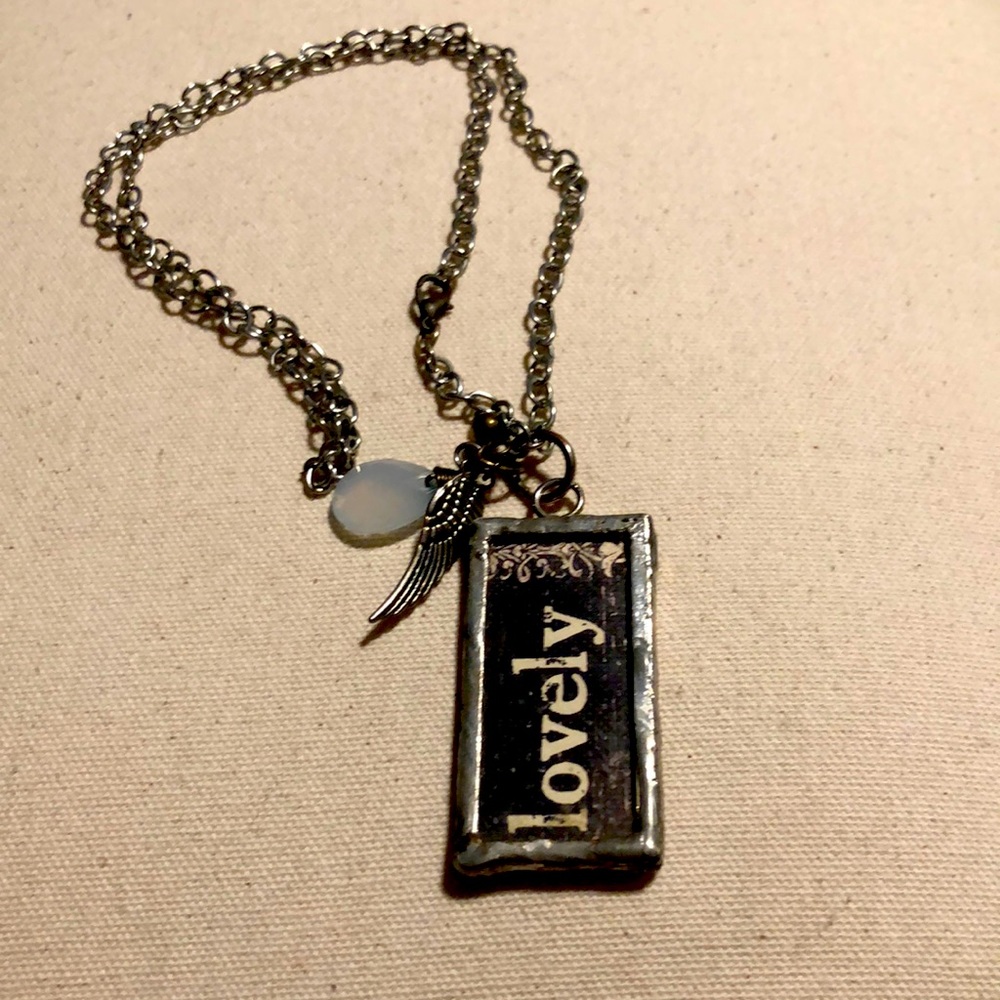 Long charm type necklace